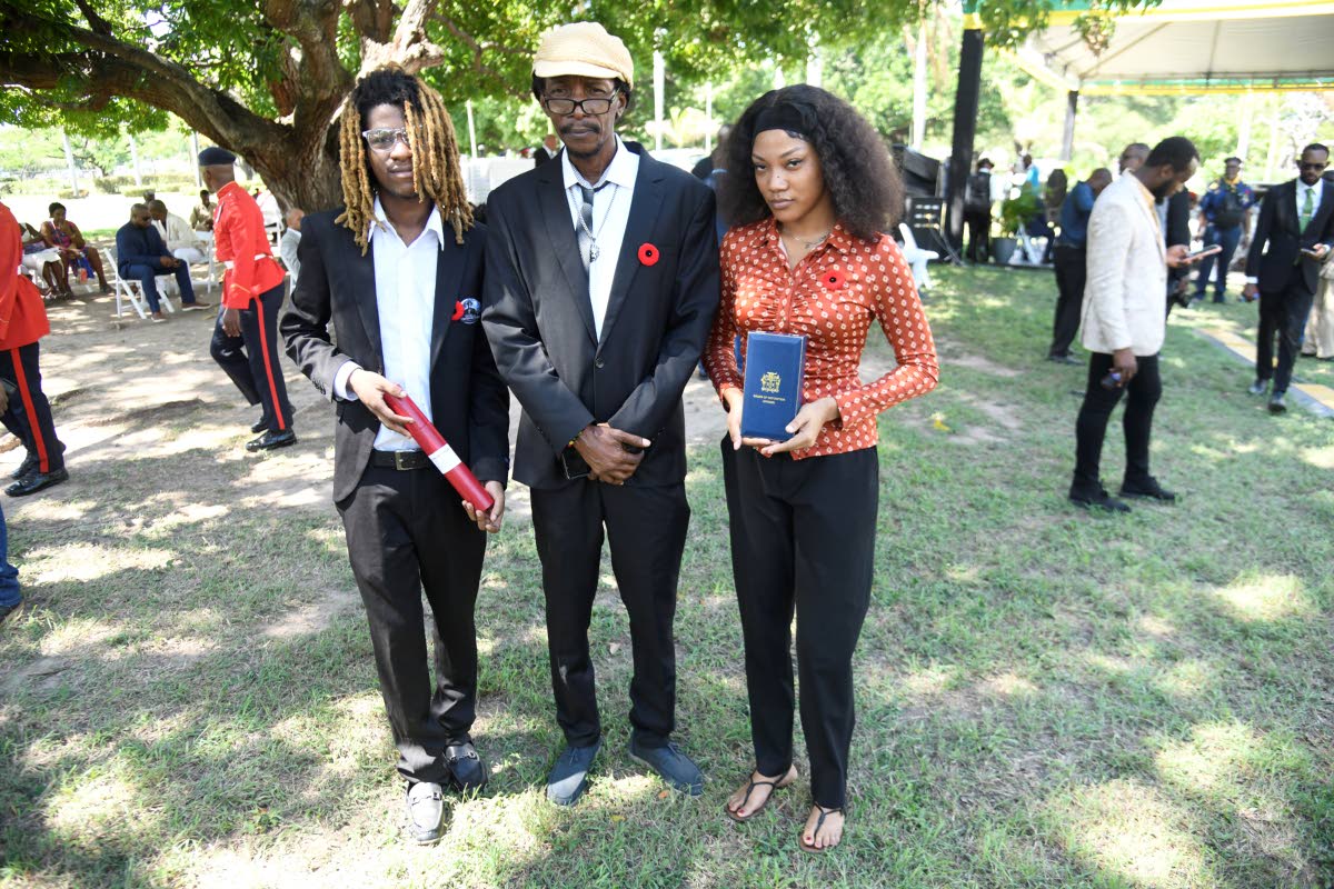 From left: Marcus Cole, Squidley Cole and Priscilla Cole, sons and granddaughter of the late Wilburn Theodore ‘Stranger’ Cole, at the National Honours and Awards Ceremony where the musician was posthumously conferred with the Order of Distinction in th