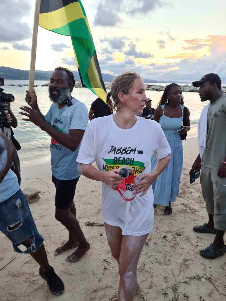 International swimmer Eva Buzo (foreground) shortly after completing a 30-kilometre swim from Trelawny to St James on Sunday. Also pictured is Dr Devon Taylor (left), president of the Jamaica Beach Birthright Environmental Movement.