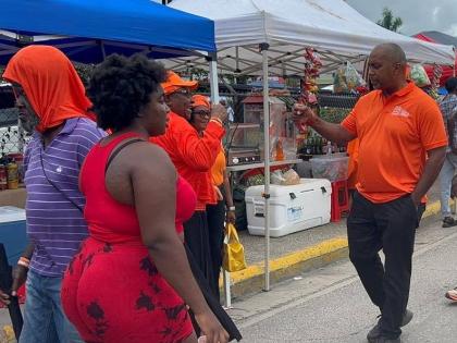 Opposition Spokesman on Finance Julian Robinson greeting People’s National Party supporters on Sunday.