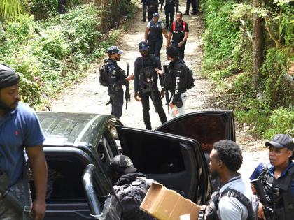 Members of the Jamaica Constabulary Force (JCF) converge at a scene in the Five Miles area of Sligoville in St Catherine, where three cops were shot, one fatally, and three gunmen killed during an operation on Friday.