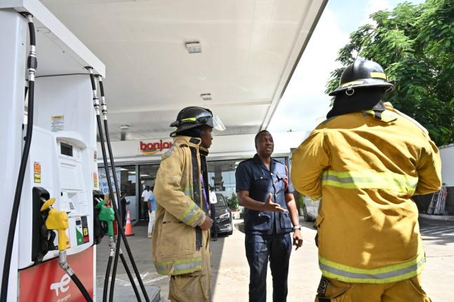 District Officer Shaun Grant of the Jamaica Fire Brigade greets firefighters from the unit which responded to TotalEnergies fire-simulation drill at its Manor Park Service Centre on September 24. Grant and Acting Sergeant Lecia Oliver, along with Terry Fos