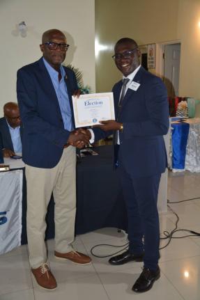Newly installed president of the Kiwanis Club of Drax Hall, Paul Barnes (left), receives the instrument of leadership from Lt Gov of Kiwanis Division 24, Josh Dwyer, during the installation ceremony at the Drax Hall Manor Club House in St Ann on September 