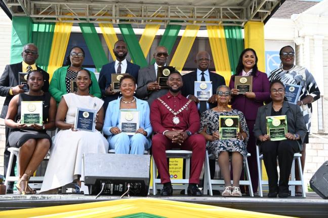 Montego Bay Mayor Richard Vernon (seated centre) in a photo-op with several of the awardees who were honoured during St James’ National Heroes Day Civic and Awards Ceremony in Sam Sharpe Square, Montego Bay, yesterday, held under this year’s theme ‘R