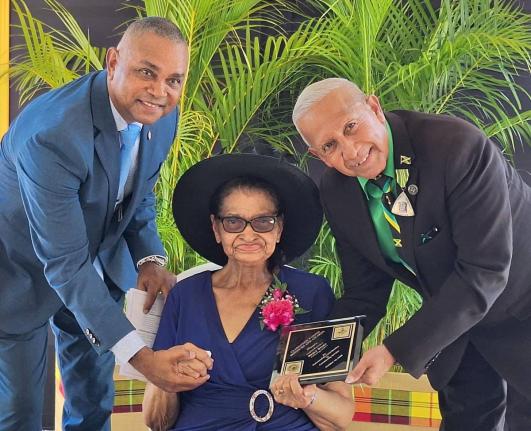 Eighty-eight-year-old Merle Stern, the oldest recipient at Monday’s National Heroes’ Day Salute Parade and Awards Ceremony, is pictured with her son, politician Michael Stern (left), and Councillor Winston Maragh, former mayor of May Pen.