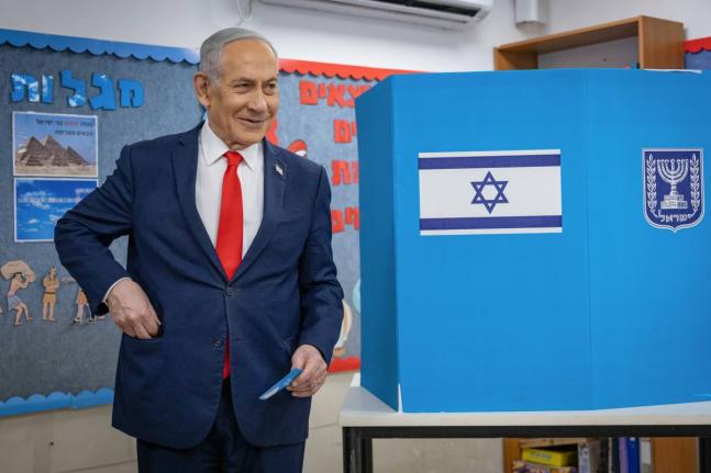 Israel’s Prime Minister Benjamin Netanyahu reacts after filling out his ballot before voting at a polling station in Jerusalem, Tuesday.